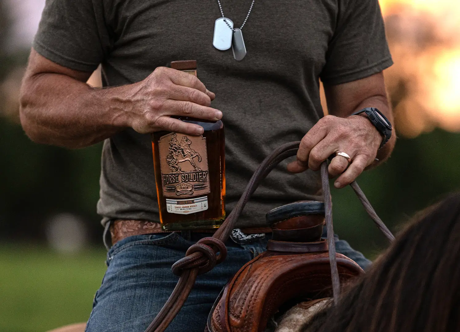 Picture of Solider riding a horse holding a bottle of Horse Bourbon